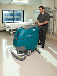 Tennant T300 Walk-Behind Floor Scrubber cleaning a patient room in a hospital Tennant T300 Walk-Behind Floor Scrubber cleaning a patient room in a hospital